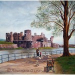 Caerphilly Castle, Wales with a family feeding the birds in the park